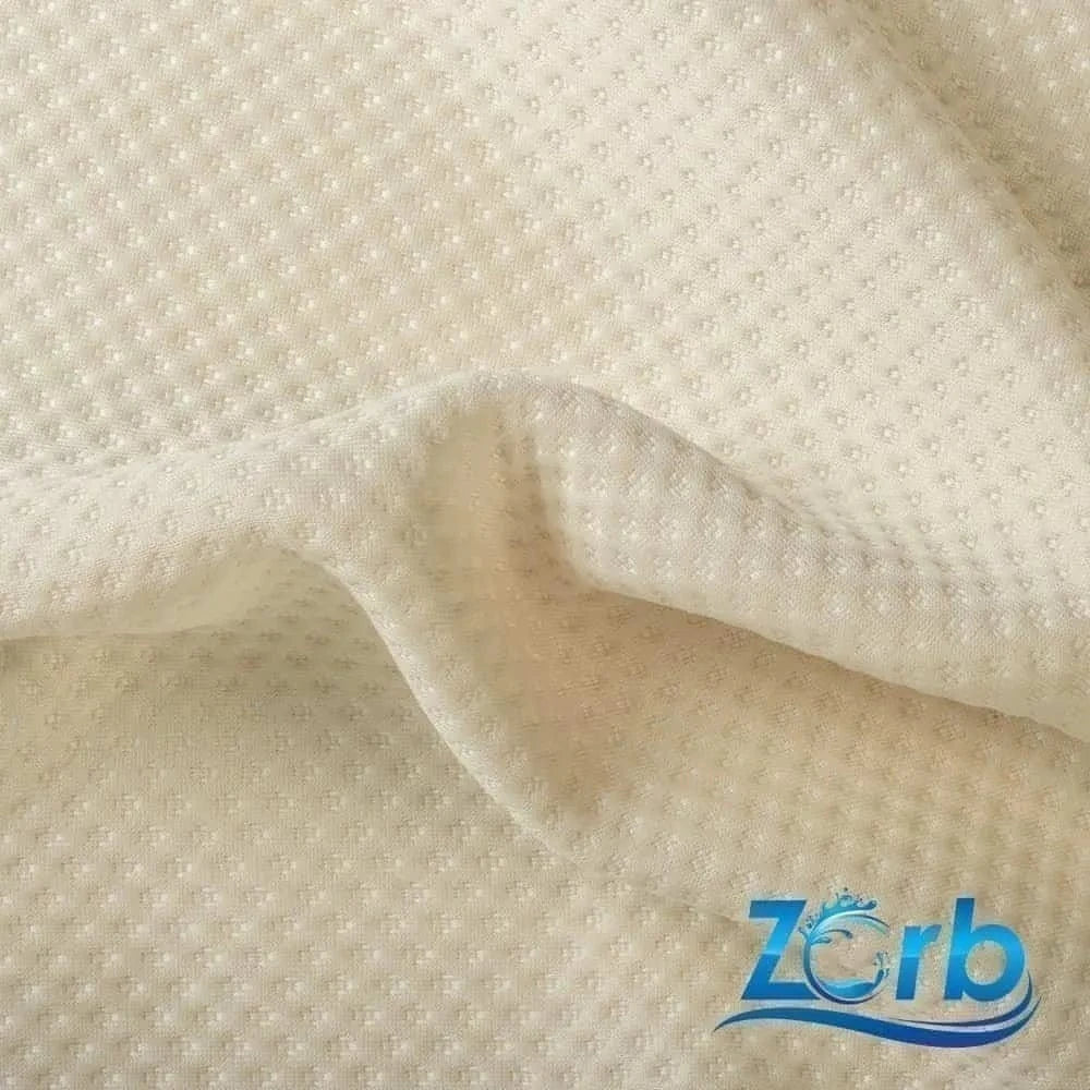 Enchanted parchment-beige fabric, adorned with a dance of raised polka-dot bumps like tiny ghostly orbs, its soft surface rippling with a touch of gothic mystery. A crescent-moon blue Zorb logo glimmers in the lower right corner—a charming seal for your small pet’s next otherworldly snuggle nest.