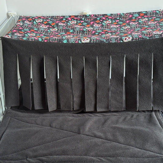 Spooky-cute alt text: The Curious Catrina Large 2x1 Fleece Forest enchants your piggy’s lair with gothic-glam flair—a plush haybox beckons tiny paws, while a shadowy fleece floor invites midnight snuggles. Sinister-cute vertical slits drape in a curtain of midnight-black fleece, perfect for mysterious scurrying. Overhead, a vivid sugar skull cats and blooming florals canopy casts magical Day-of-the-Dead vibes atop this whimsical hideaway for small critters!.