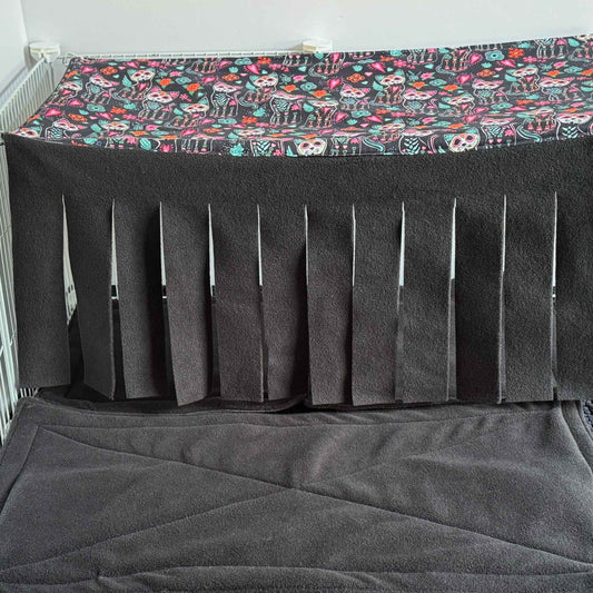 Spooky-cute alt text: The Curious Catrina Large 2x1 Fleece Forest enchants your piggy’s lair with gothic-glam flair—a plush haybox beckons tiny paws, while a shadowy fleece floor invites midnight snuggles. Sinister-cute vertical slits drape in a curtain of midnight-black fleece, perfect for mysterious scurrying. Overhead, a vivid sugar skull cats and blooming florals canopy casts magical Day-of-the-Dead vibes atop this whimsical hideaway for small critters!.