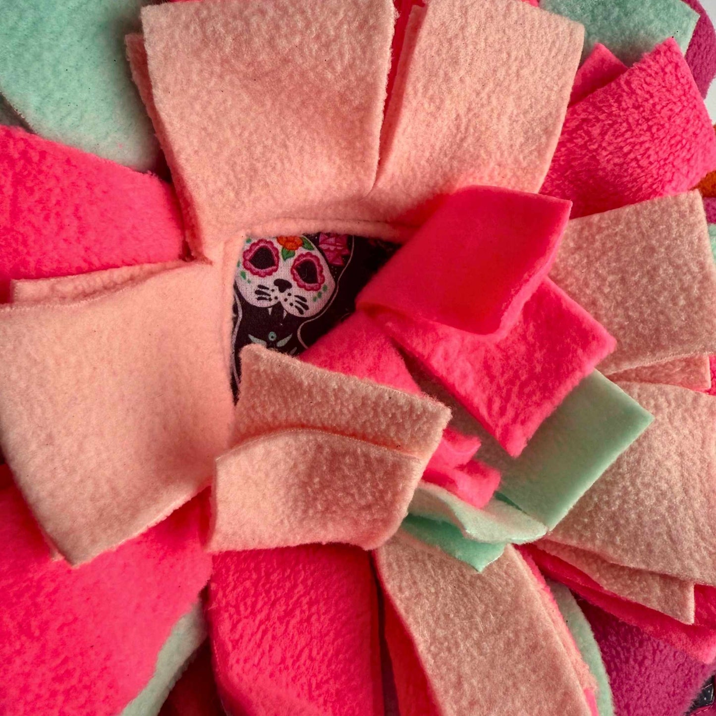 Enchanting close-up of the Curious Catrina Snuffle Mat—pastel petals in goth-glam layers, with a bewitching cat visage at center.