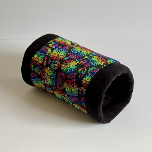 The Frightful Fiesta Snuggle Tunnel—a whimsical hideaway for your tiny familiars! This gothic-glam tube features a plush, velvety black lining perfect for midnight lounging, while the outer fleece dazzles with a parade of pastel rainbow cats and enchanted blooms. Set against a white background, it’s the ultimate blend of spooky sweetness—ideal for guinea pigs and small pets seeking cozy comfort with a dash of magical mischief.