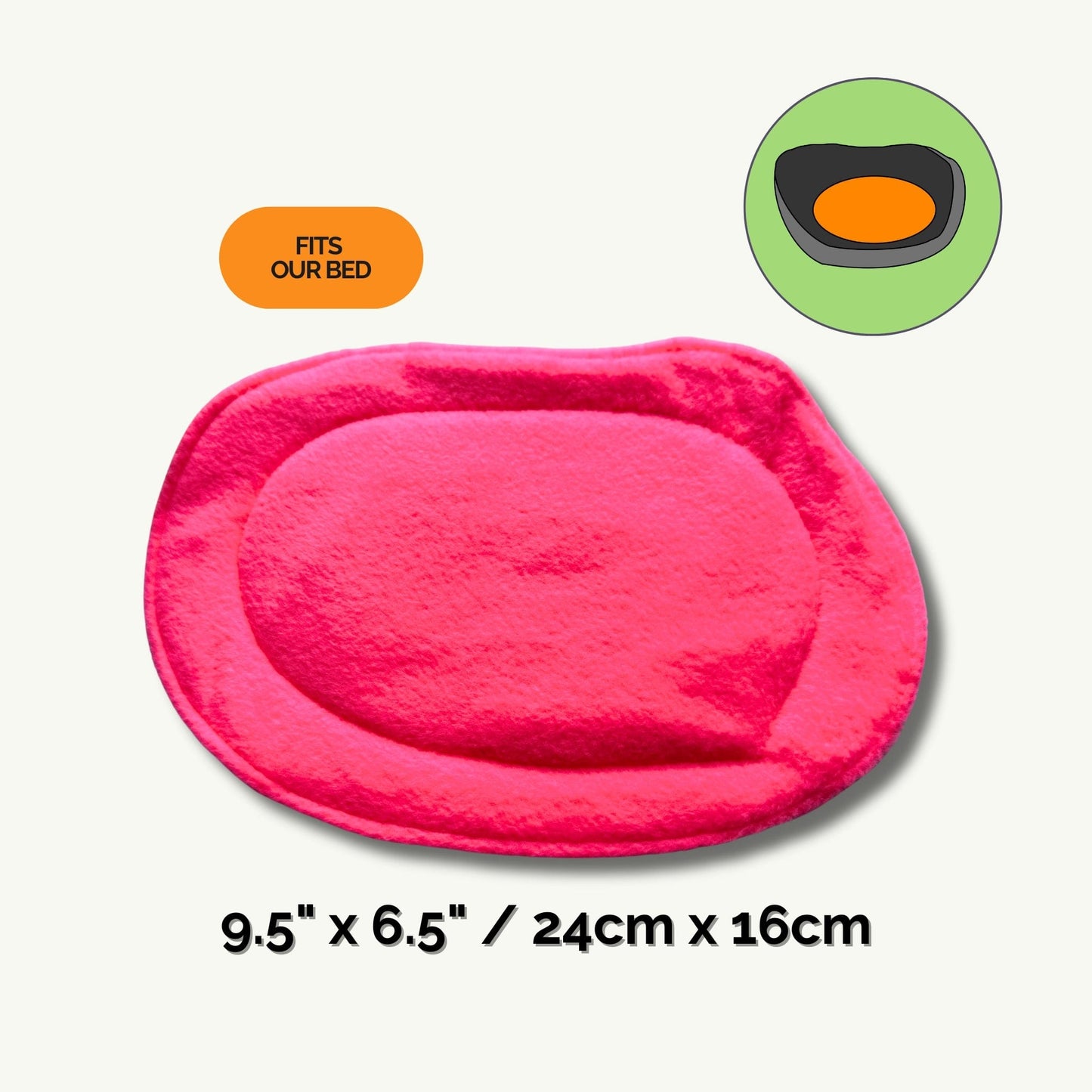 Bewitchingly bright pink oval pee pad liner (9.5 x 6.5 in / 24 x 16 cm), stitched with enchanting care for the tiniest familiars. Features an orange “Fits Our Bed” label, adorned with a charming illustration of the liner snuggled inside a cozy green pet bed—perfect for your little creature’s lair. Product: Pee Pads | Summon convenience and keep your gothic-glam castle sparkling, one magical clean-up at a time.