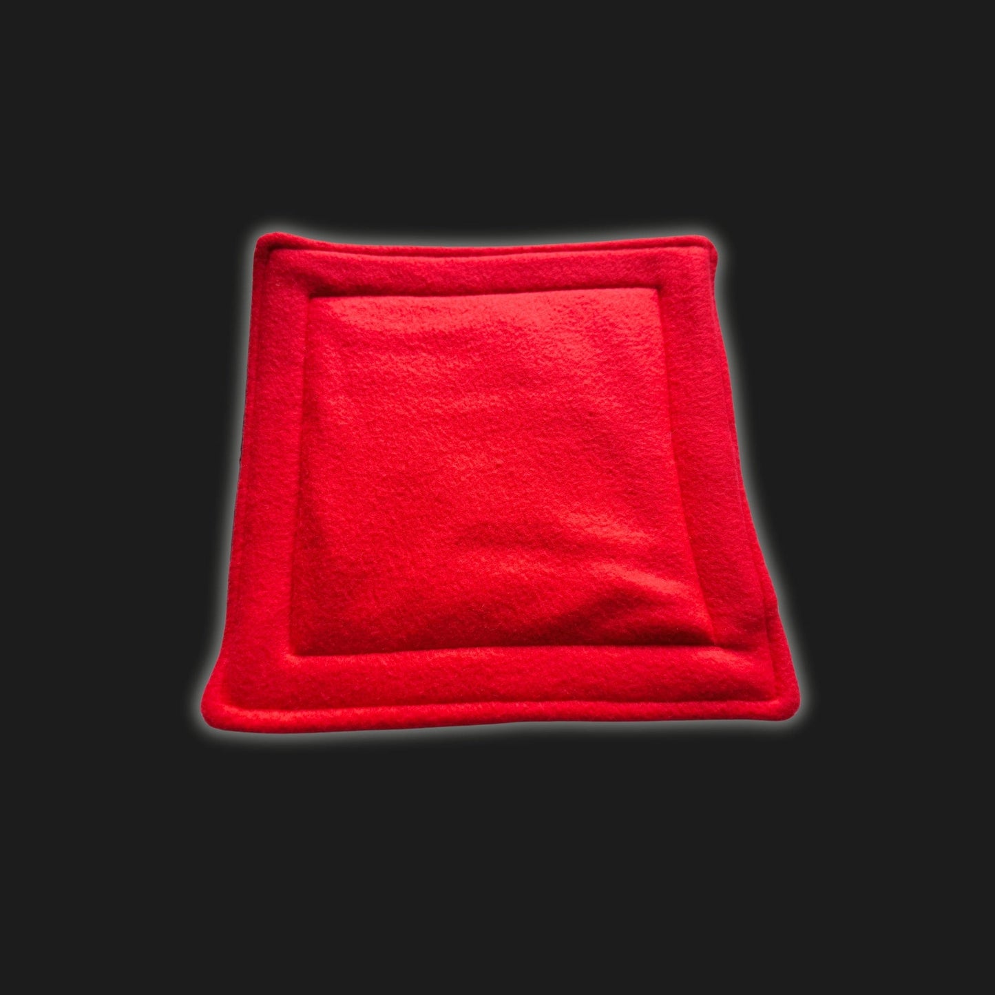 A bewitchingly cozy, blood-red fleece liner and matching petite pee pad for small pets—plush squares edged in gentle piping, like a velvet cushion fit for gothic royalty. Resting atop a mysterious black backdrop, this handmade accessory is delightfully soft, shimmery with gentle luster, and promises snug comfort with an enchanting touch—perfect for guinea pigs and tiny familiars craving comfort in style. Washable and practical magic woven into every stitch!.