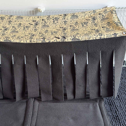 Hauntingly adorable and just a touch glam, the Tombstone Tango Large 2x1 Fleece Forest enchants your piggies’ realm with gothic flair! A soft beige fleece canopy adorned with swirling Día de los Muertos motifs casts mysterious charm from above, while draping midnight-black fleece fronds sway like shadows below. A plush, cushioned mat in sleek black invites your tiny familiars to snuggle up or scurry through—the perfect hideaway for cage-dwelling sweeties craving a dash of spectral elegance.