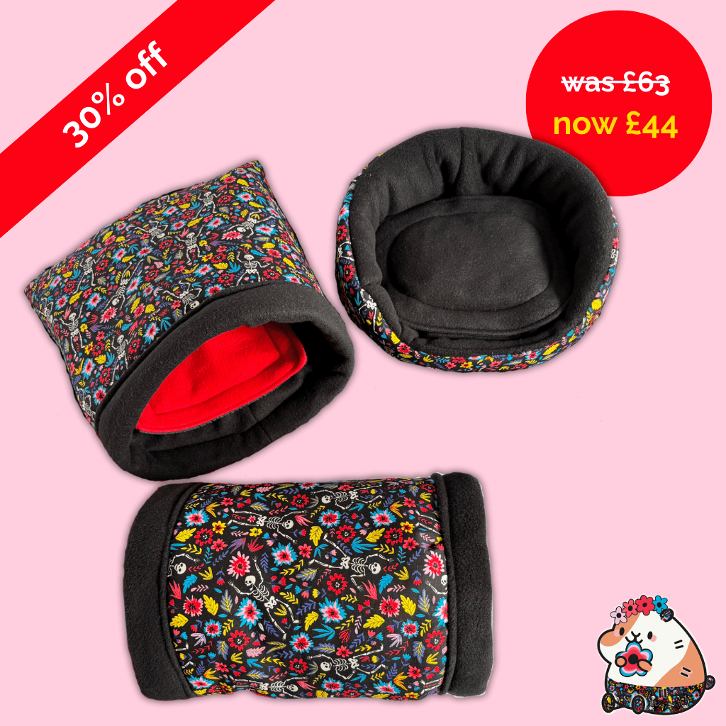 Blooms & Bones Bundle: three black & floral snuggle sacks and tunnels rest on pink, 30% off banner, gothic-cute cartoon in corner.
