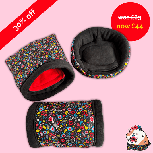 Blooms & Bones Bundle: three black & floral snuggle sacks and tunnels rest on pink, 30% off banner, gothic-cute cartoon in corner.