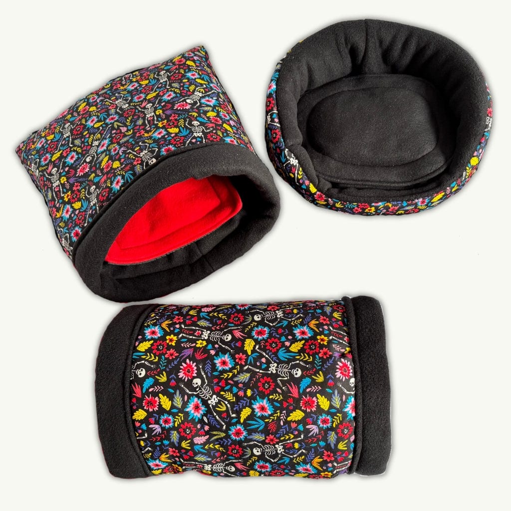 Blooms & Bones Bundle: three bewitching pet beds—floral prints, black fleece, and a red-lined snuggle sack—for cozy gothic cuddles!.