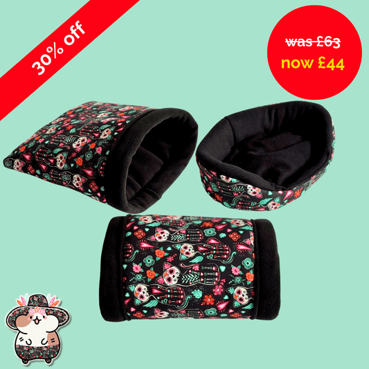 Trio of plush beds in gothic skull prints—Curious Catrina set—on mint green. Spooky sale: “30% off, was £63 now £44.” Cute hamster in floral hat peeks playfully.