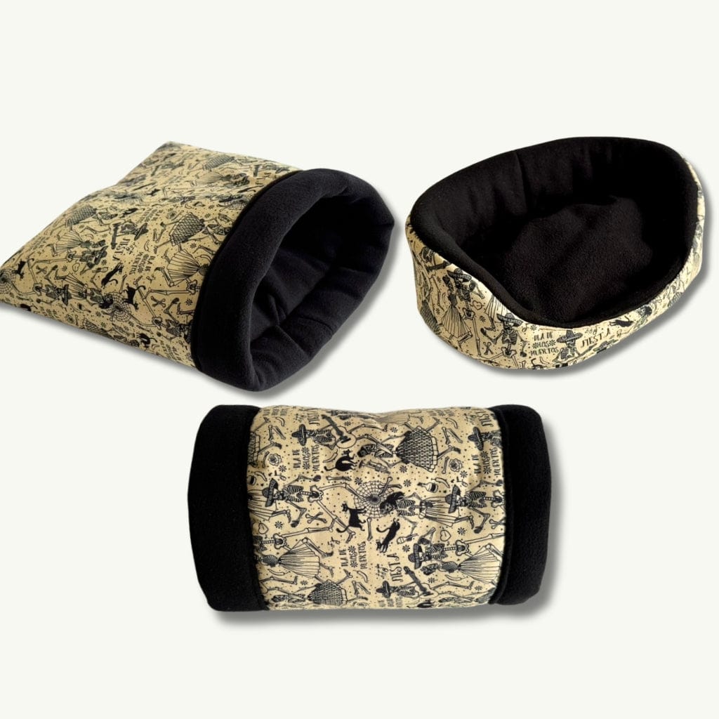 Enchanted beige fleece tombstone beds, lined in inky black, flaunt playful gothic sketches—spooky-cute snuggles for little familiars.