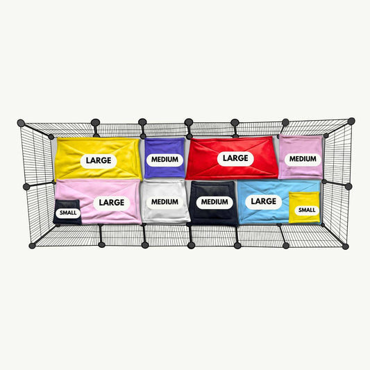 A bewitching wire rack cradles ten Blooms & Bones Pee Pads—small, medium, and large—snugly sorted in shadowy cubbies.