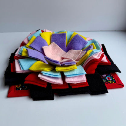 The Blooms & Bones Snuffle Mat enchants with pastel petals atop a vampy red-and-black base, conjuring a gothic treat hunt for pets.