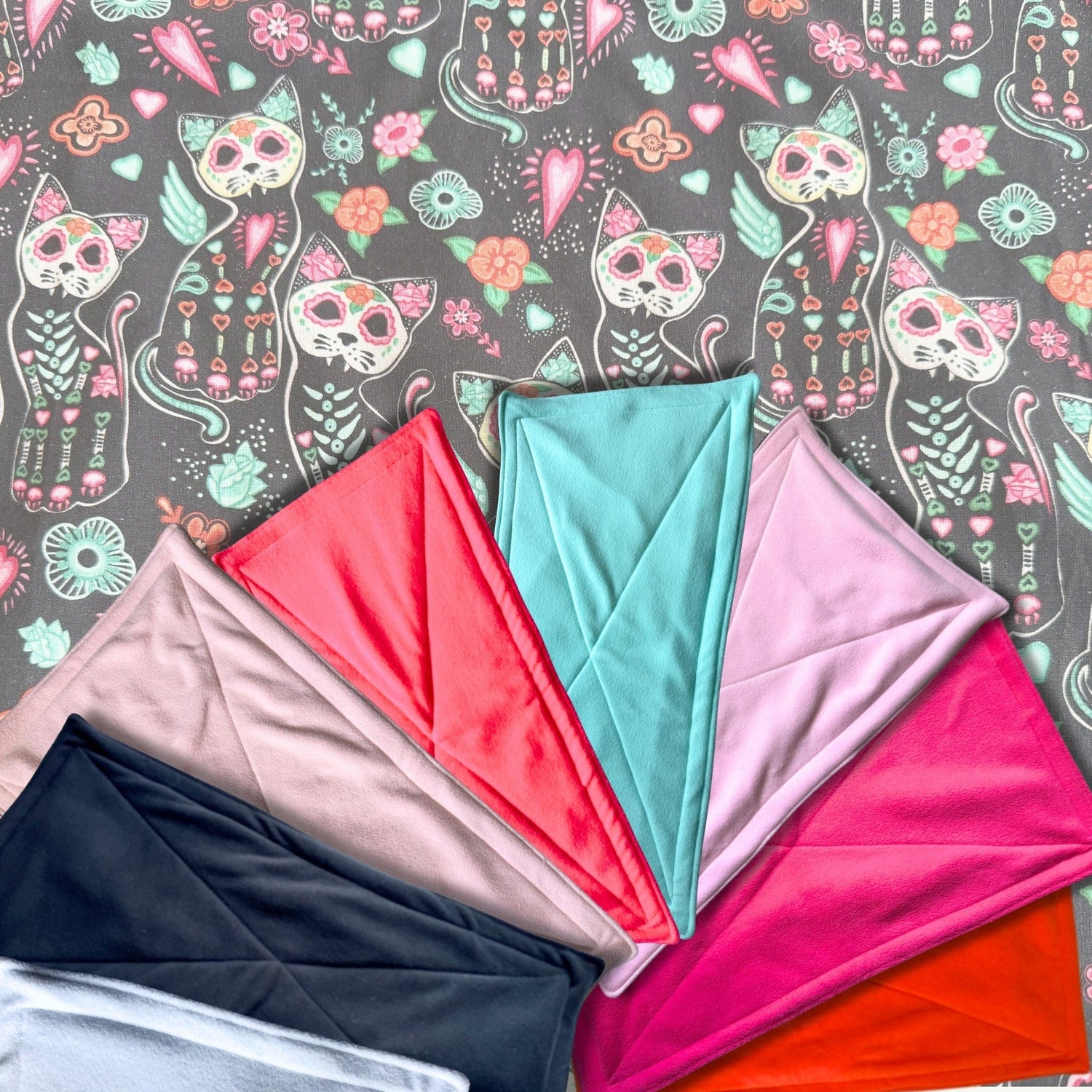 Seven enchanting fabrics spread like a midnight fan across a backdrop of mischievous cats, gothic-chic flowers, and whimsical sugar skulls. These Curious Catrina Matching Pee Pads add a spell of spooky-cute charm to your guinea pigs’ lair—casting away messes with hauntingly absorbent magic and making every clean-up delightfully glam.