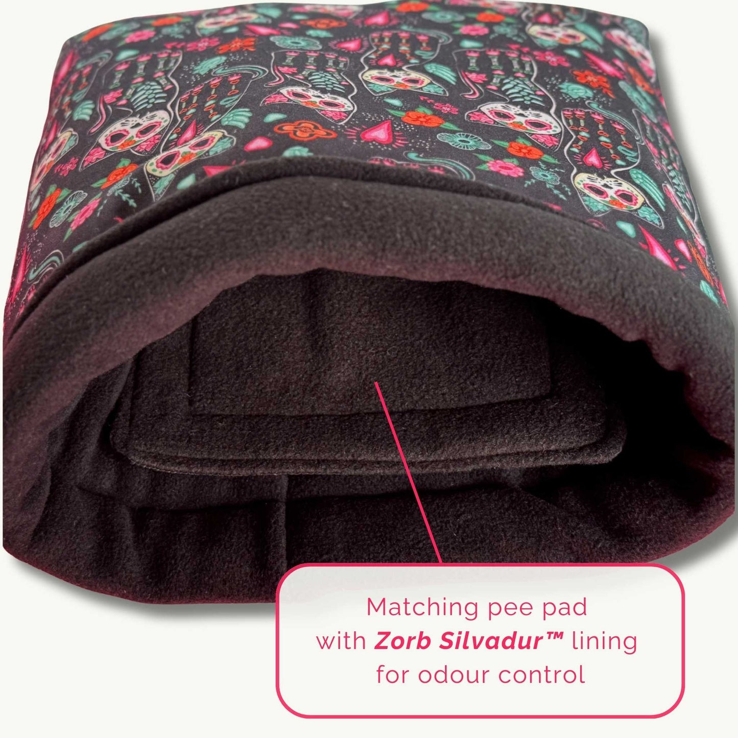 Enchant your guinea pig with this gothic-glam snuggle sack—festive skeletons, plush black fleece, and a Zorb Silvadur™ pee pad inside.