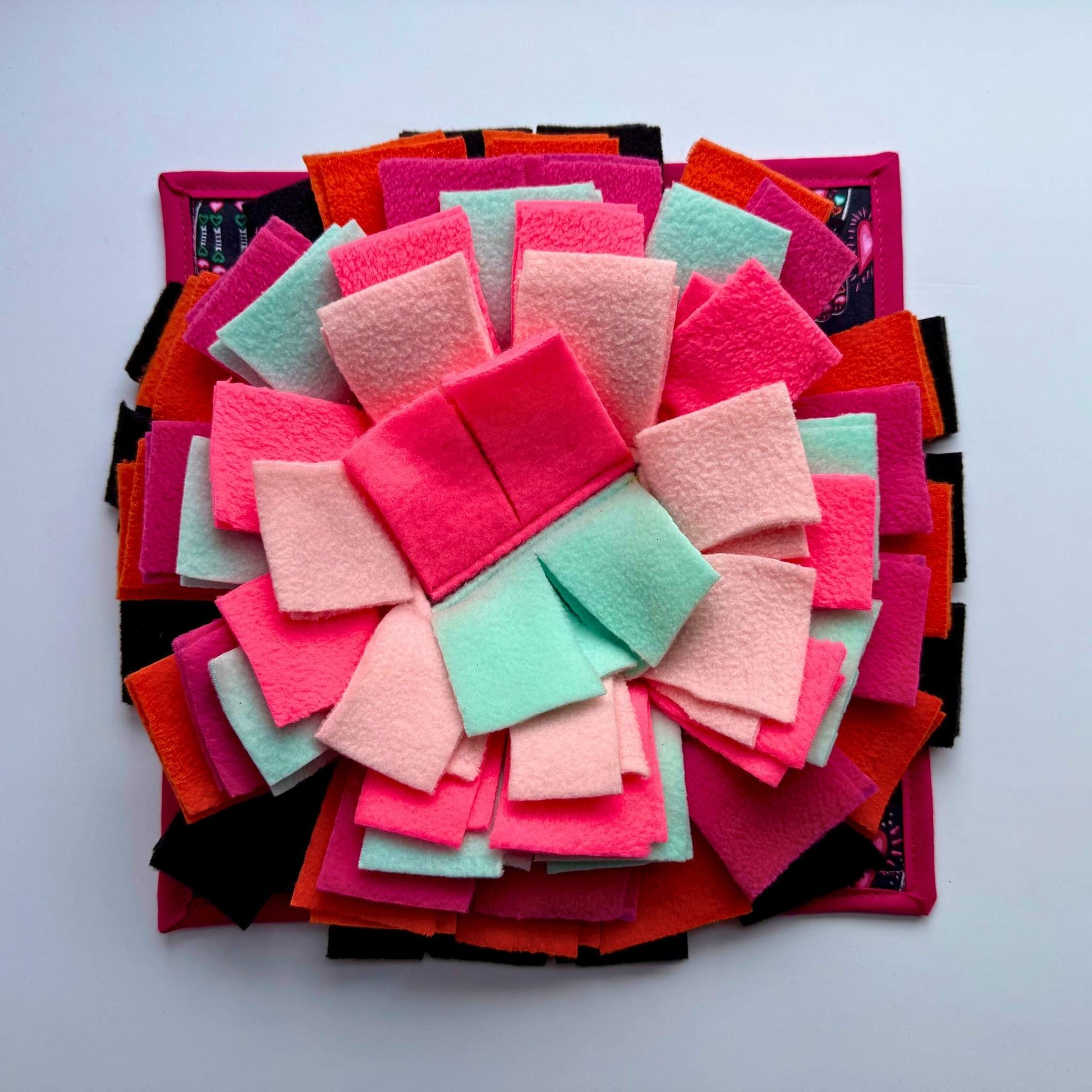 The Curious Catrina Snuffle Mat blooms in gothic pink, red, mint, and black felt—hauntingly fun enrichment for your little familiar.