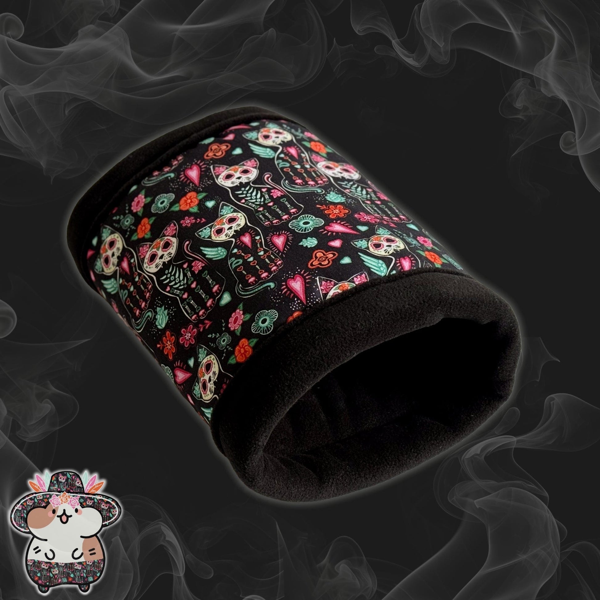 The Curious Catrina Fleece Tunnel enchants with gothic-glam flair—a plush black tunnel for guinea pigs, adorned in lively sugar skull cats and whimsical blossoms swirling across a dusky, smoky backdrop. A tiny illustrated mouse peeks playfully from the bottom left corner, adding a dash of adorable mischief for your spooky-cute companion.