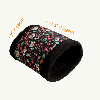 Enchant your guinea pig’s lair with the Curious Catrina Fleece Tunnel—a goth-glam hideaway draped in midnight-soft fleece. Adorned with whimsical sugar skull cats and dreamy florals in jewel tones, this cozy tunnel beckons little familiars to burrow inside for a spectral snooze. Measures approximately 7 inches (18 cm) wide by 11.5 inches (29 cm) long—perfect for petite spirits seeking stylish comfort.