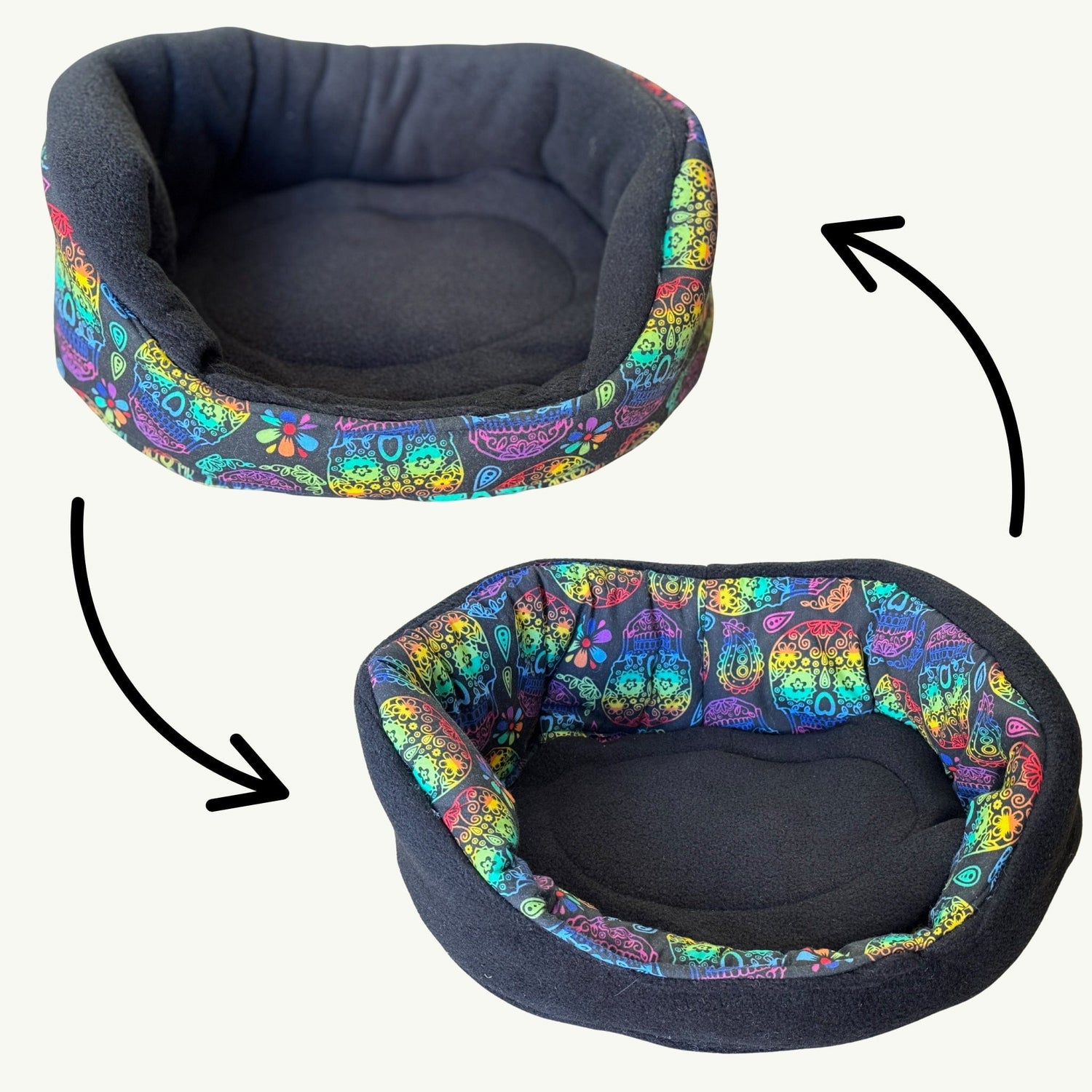Two enchanting glimpses of a snuggly small pet bed, one side draped in midnight-black plush for shadowy naps, the other a riot of gothic whimsy with vibrant cat faces and bloom-laced patterns around the rim. Mysterious black arrows beckon, revealing the bed’s bewitching reversible magic—perfect for guinea pigs or tiny familiars seeking comfort with a dash of glam.