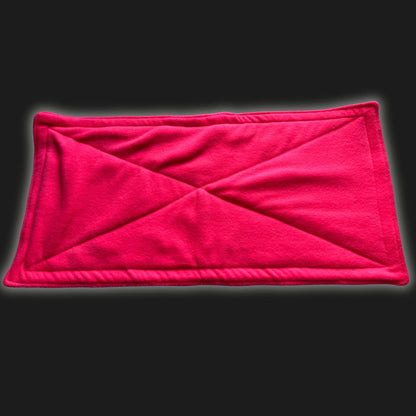 A bewitching neon pink fleece liner and pee pad set, stitched with enchanting diagonal and border lines like a cozy spell. The plush, rectangular pads lie atop a midnight-black backdrop—perfect for pampered guinea pigs and small familiars seeking gothic-glam slumber. Washable, magical, irresistibly soft!.