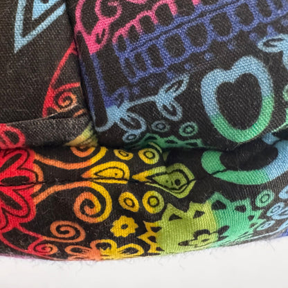 A close-up of luxurious fleece fabric, swirling with vibrant rainbow-gradient paisley and gothic florals that glow like moonlight against an inky black background—perfect for creating a spooktacular Frightful Fiesta Fleece Bed or a cozy, enchanted nest for your guinea pig’s midnight dreams.