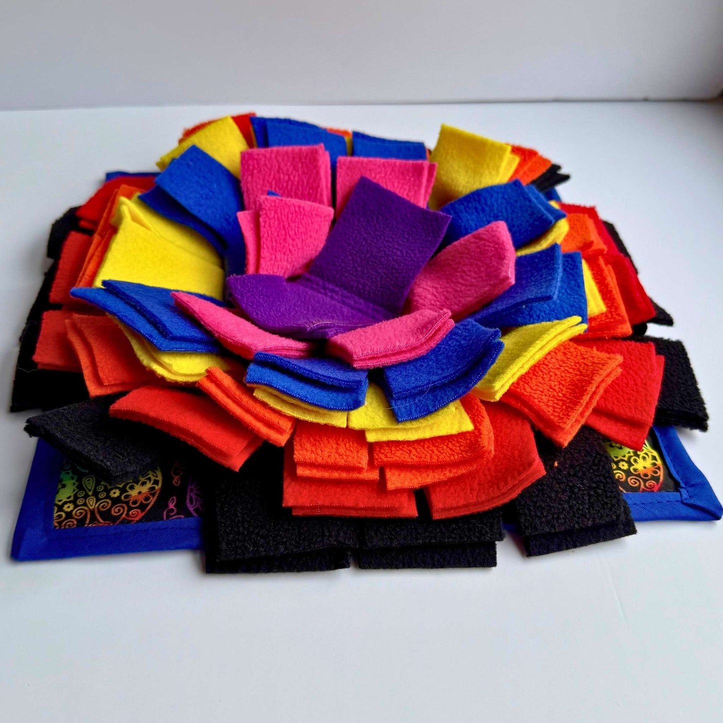 The Frightful Fiesta Snuffle Mat blooms in gothic-glam reds, yellows, purples, blues, and black—an eerie-cute flower of treats.