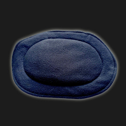 Bewitchingly cozy and unmistakably chic, this Modular Fleece Liner & Pee Pad casts a midnight spell in deep, inky black. The oval-shaped pad boasts luxuriously soft fleece, a gently puffed center like a moonlit cloud, and elegantly stitched edges for that darkly romantic flair. Perfect for your little crypt-creature’s cage or playpen—shown here dramatically resting on an equally mysterious black backdrop.