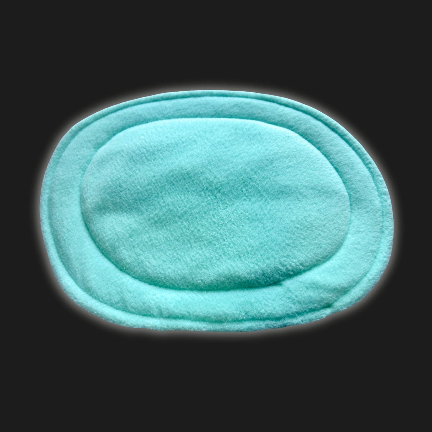 Enchanting mint green modular fleece liner and matching pee pad, draped like velvety moonlight against a deep, gothic-black background. Silky-soft fleece beckons tiny paws, while bewitching stitched edges add fanciful charm. Perfectly plush for pampered guinea pigs or small pets—use as a washable pee pad or waterproof cage liner to keep their lair both cozy and glamorously ghost-free.