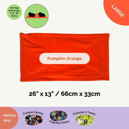 The Trickster's Treats Pee Pad haunts with plush pumpkin-orange fleece, gleaming gothic-chic for Halloween cage sets, 26"x13".
