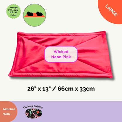 The Wicked Neon Pink Fleece Liner (26x13in/66x33cm) enchants your guinea pig’s castle with a burst of gothic-glam colour, glowing like a mischievous witch’s potion. Crafted for average-sized piggies, this plush liner conjures away odours and absorbs spooky little spills. Pair it with the Curious Catrina Matching Pee Pads for a hauntingly cute, stress-free cleaning ritual that keeps your small pet’s realm both bewitching and tidy.