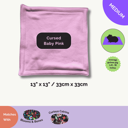 A 13x13" square, Cursed Baby Pink fleece pee pad—soft, spooky-cute, and odour-resistant for your gothic-glam piggy’s lair.