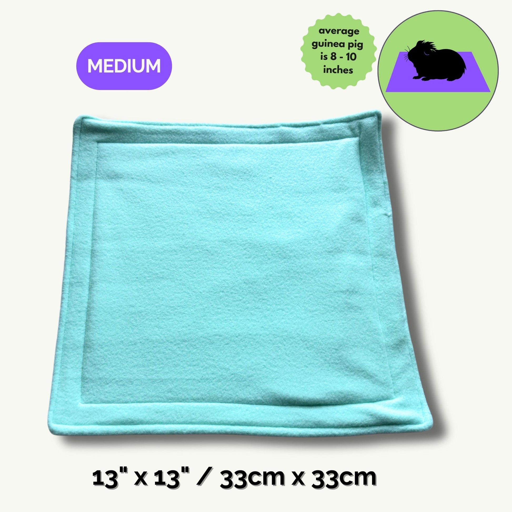 A dreamy, pastel blue pee pad (measuring 13x13 inches / 33x33 cm) rests enchantingly atop a ghostly pale backdrop. Adorned with a whimsical Medium tag and an illustrated guinea pig—charmingly crowned with the note average guinea pig is 8-10 inches—this cozy pad brings gothic-glam flair to your small pet’s lair. Perfect for keeping your familiars’ abodes spellbindingly clean and snuggly, all while turning daily chores into a breeze with a touch of whimsy.