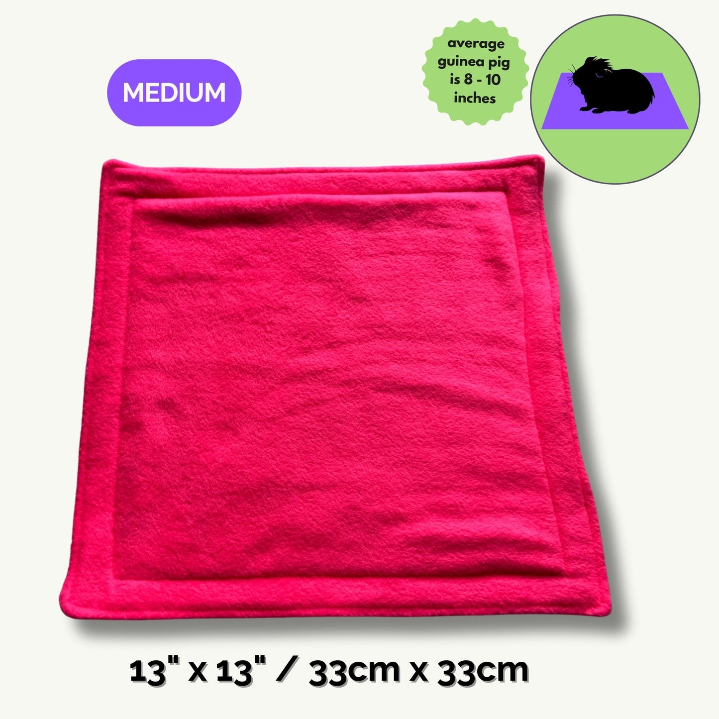 A bewitchingly bright pink pee pad (13 x 13 inches / 33 x 33 cm, Medium) unfurls across the scene—soft as midnight velvet and trimmed with gothic charm. Nearby, a darling cartoon guinea pig (8–10 inches long) sits cozily for size reference, whiskers twitching with delight. Make your small pet’s cryptic castle both plush and pristine—this enchanted fleece mat turns tidying up into a hauntingly easy ritual.