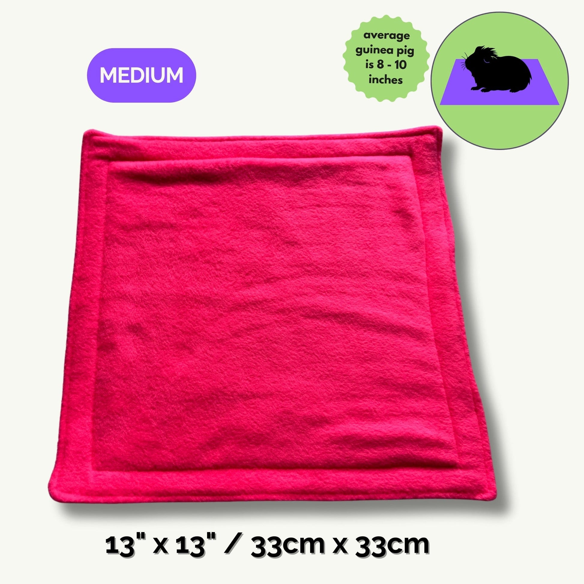 A bewitchingly bright pink pee pad (13 x 13 inches / 33 x 33 cm, Medium) unfurls across the scene—soft as midnight velvet and trimmed with gothic charm. Nearby, a darling cartoon guinea pig (8–10 inches long) sits cozily for size reference, whiskers twitching with delight. Make your small pet’s cryptic castle both plush and pristine—this enchanted fleece mat turns tidying up into a hauntingly easy ritual.