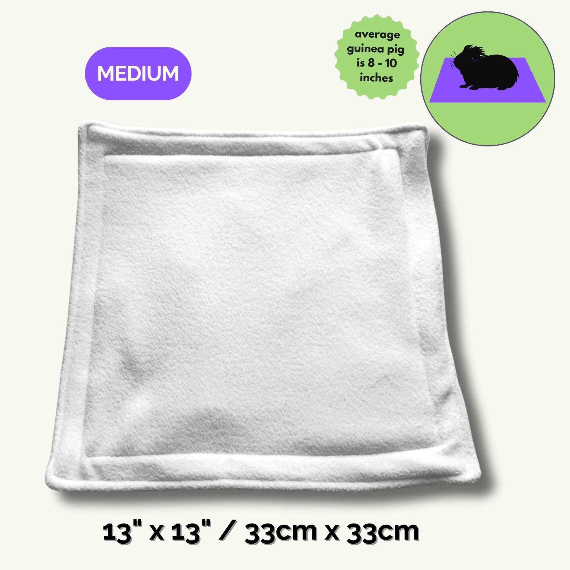 The Pee Pads | Turn daily cleanup into a spellbinding breeze—our ghostly-soft, square fleece pad (13 x 13/33cm x 33cm) summons gothic glam with its crisp white surface, vibrant purple MEDIUM label, and an enchanted green guinea pig illustration. Perfectly sized for your darling familiars (average guinea pigs, 8–10 inches), this pad brings a dash of whimsical charm and moonlit magic to every cozy corner.