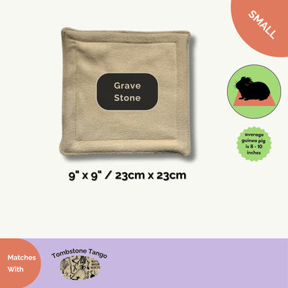 The Tombstone Tango Matching Pee Pad, in softly haunted beige (9x9), offers gothic glam for your small pet’s lair—cozy, absorbent, and odor-banishing for ghostly clean cages. Adorned with tiny illustrated tombstones beside a flowing black banner announcing perfect pairing with our Grave Stone pad; size options are neatly showcased. Whimsical yet practical, it makes daily cleaning a breeze for guinea pigs and other enchanting little familiars.
