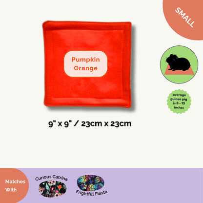 The Curious Catrina Matching Pee Pads—a bewitching pair of small, square pads (9x9” / 23x23cm) in vivid pumpkin orange—await your tiny familiar! These absorbent, soft mats bring gothic-glam flair to any guinea pig’s lair. Perfect for cozy corners or spooky snuggle spots, they charm away mess and enchant your space. Designed to match our two enchanting Day of the Dead-inspired prints below, these pads are a fiendishly stylish upgrade for both practical magic and show-off-worthy décor.