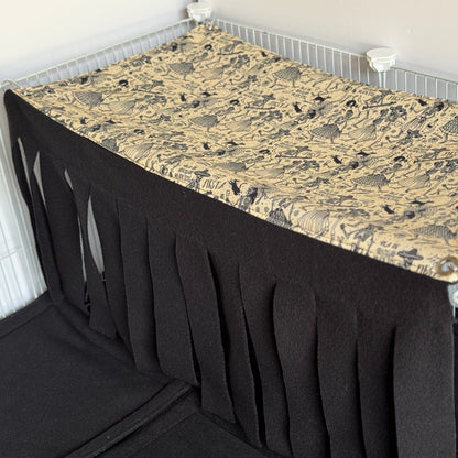 Step into the mystical midnight waltz with our Tombstone Tango Large 2x1 Fleece Forest—a bewitching Día de los Muertos-inspired hideaway for your piggies! Features a gothic-chic black and tan illustrated pattern of whimsically carved tombstones and sugar skulls, with plush fleece strips cascading like enchanted curtains to create a cozy, shadowy nook perfect for spooky-cute snuggles in their cage.
