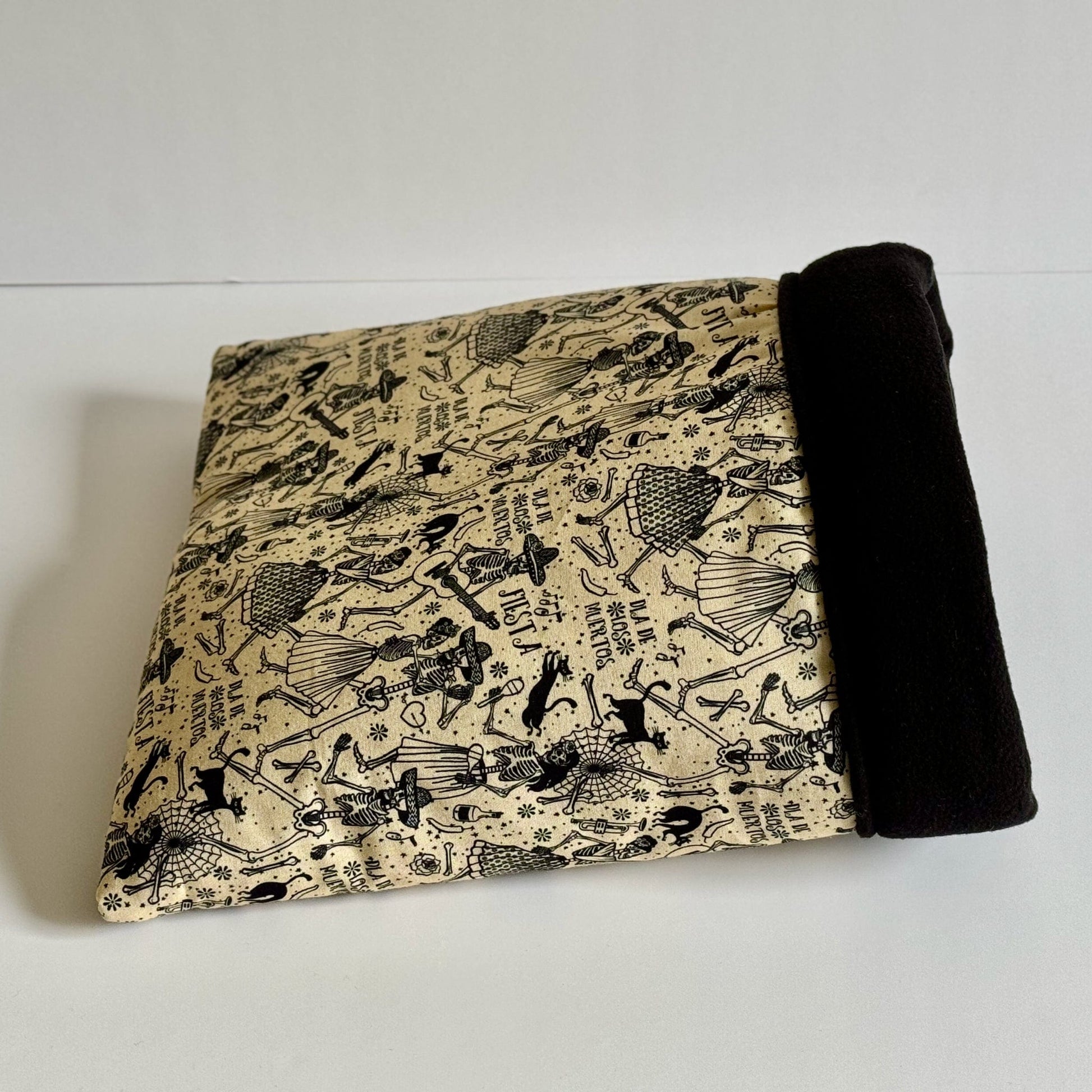 The Tombstone Tango Snuggle Sack beckons your little beastie into gothic comfort—crafted from bewitching tan cotton cloaked in black, featuring mysterious ancient Egyptian pharaohs, fabled creatures, and cryptic symbols dancing across the fabric. Inside, midnight-black fleece offers plush warmth for your guinea pig or small pet to snuggle up like a sarcophagus slumberer. An enchanting hideaway for pint-sized familiars who crave cozy chills!.