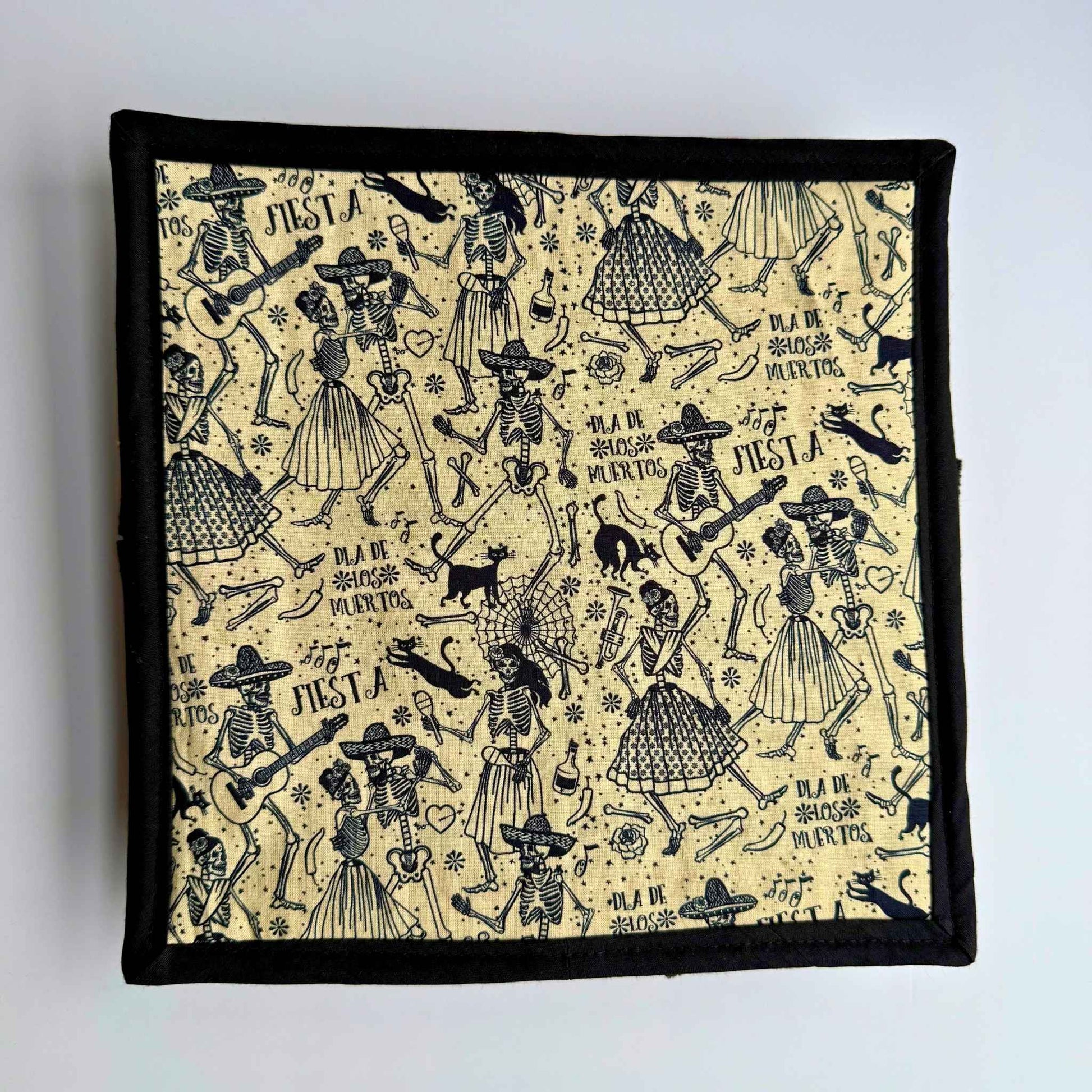 Ghoul-chic snuffle mat with lively skeletons and guitars on beige, framed in black—spooky-fun for small pets’ treat hunts!.