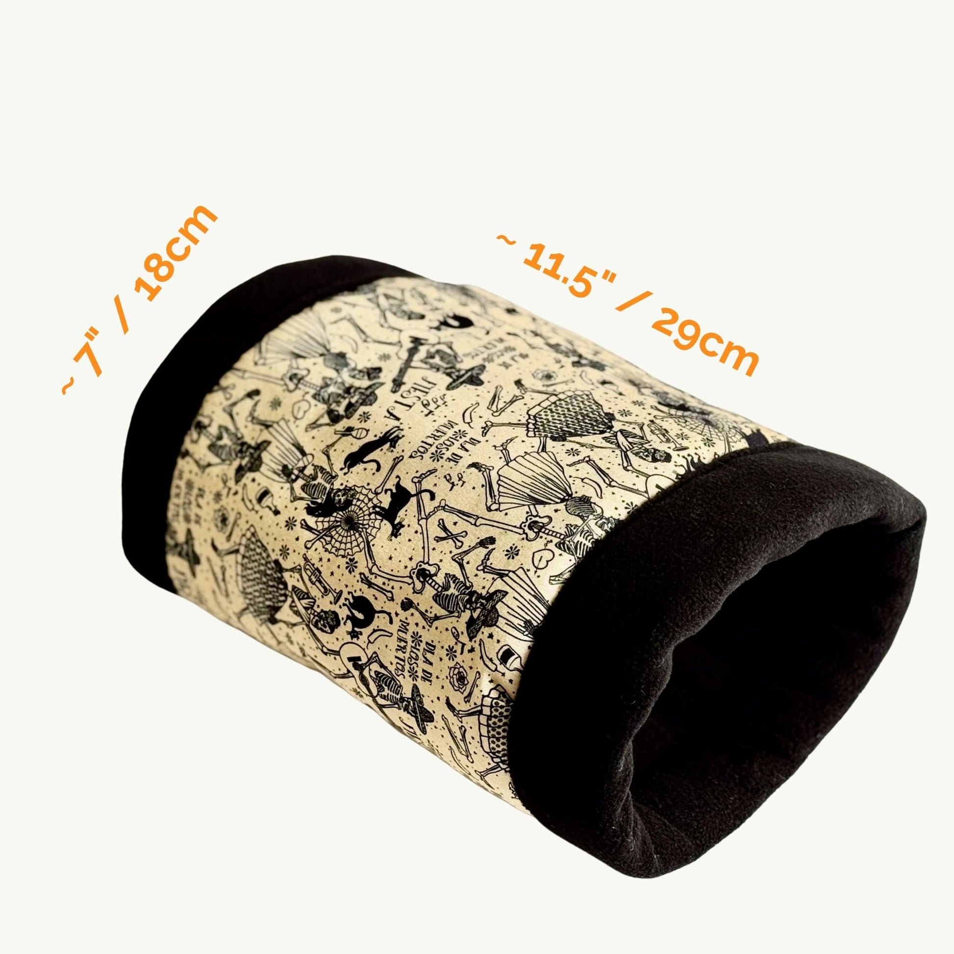 The Tombstone Tango Fleece Tunnel invites tiny familiars to shimmy through shadows in style. This plush, cylindrical hideaway—7 inches wide by 11.5 inches long—boasts midnight-black ends and a whimsical beige body adorned with gothic-glam florals, dancing cartoon skeletons, and charmingly spooky motifs. Perfect for guinea pigs or small critters craving a cozy haunt with a touch of hauntingly adorable flair.