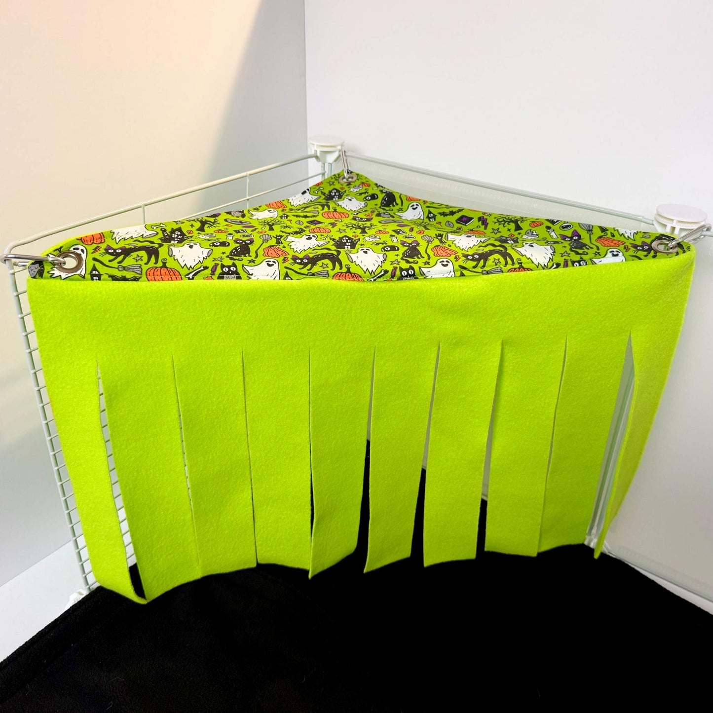 The Trickster’s Treats Corner Fleece Forest—gothic-lime ghosts, fluttery fringe, and glam coziness—await tiny snuggling familiars.