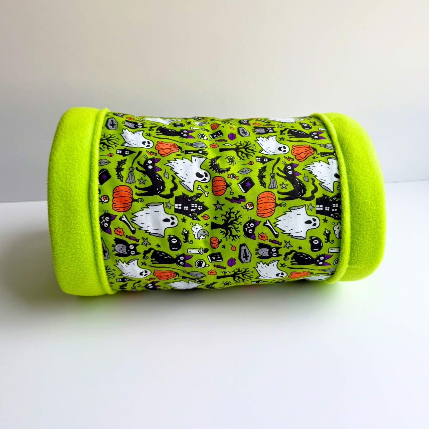 Enchant your guinea pig with a gothic-glam fleece tunnel—vivid green rim, plush lining, and spooky-cute ghosts, bats, and pumpkins.